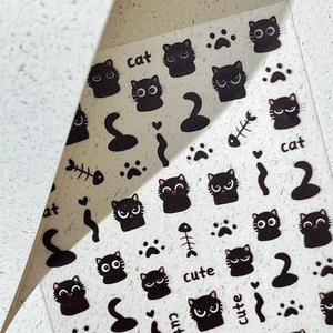 Minimalist black cartoon cat nail stickers with cute cat head and paw print patterns