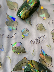 Macro view of 3D holographic leaf nail art stickers with Deep Forest laser effects