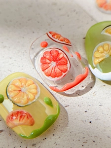 Macro detail of 3D embossed fruit nail art stickers with realistic water drop textures