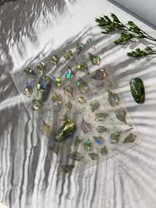 Detailed holographic forest leaf nail art sticker with sparkling green leaf patterns