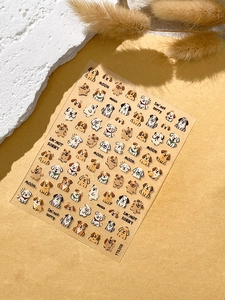 Detailed view of cute cartoon puppy nail art stickers with various dog breeds on warm background