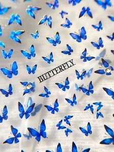 Macro shot of blue glitter butterfly nail art stickers with sparkly rhinestones