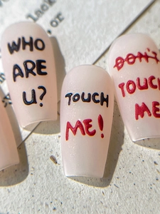 Detailed macro view of coffin nail stickers with hand-drawn black and red letter typography