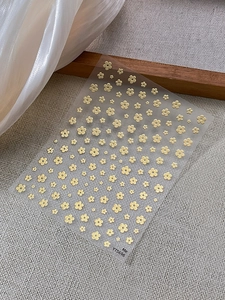 Macro detail of YT5696 nail art stickers featuring delicate yellow floral patterns