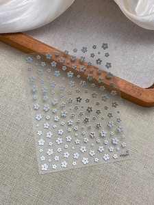 Detail of YT5697 floral nail stickers with silver metallic and matte white flower patterns