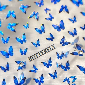 Sparkling laser blue butterfly nail art stickers with glitter and rhinestones on white base