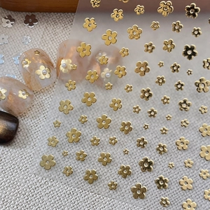 3D gold flower nail art stickers with minimalist floral designs on a transparent sheet