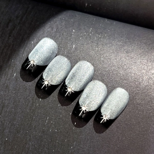 Sparkling starburst nail stickers with silver glitter and black French cat-eye design