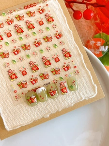 Close-up of Lunar New Year nail art stickers with red envelopes and firework patterns