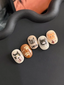 Detailed macro view of cute cartoon cat nail art stickers with glossy resin finish