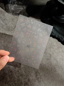 Detailed laser firework nail sticker with holographic metallic finish stars on dark base