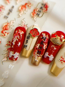 Detail of 3D Chinese New Year nail art stickers with koi fish and gold leaf accents