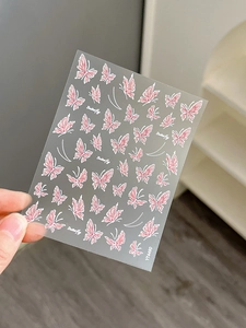 Close-up of YT4490 nail art stickers featuring pink butterfly and pearl designs