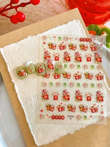 Detailed view of Lunar New Year nail art stickers with red envelopes and mahjong motifs