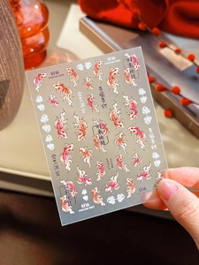 Detail of red and gold koi fish nail art stickers with traditional Chinese fortune symbols