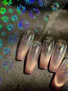 Macro detail of laser holographic firework nail stickers on cat-eye gradient coffin nails