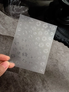 Detailed 5D embossed white fireworks nail sticker sheet with laser gold fireworks motifs