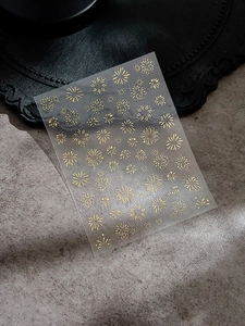 Detailed view of laser gold firework nail stickers YT4256 on a vintage background