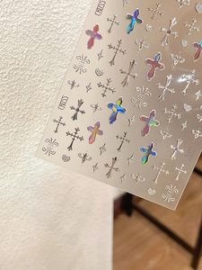 Detail of holographic silver gothic cross nail stickers with metallic laser effect