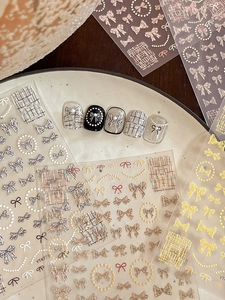 Detailed relief nail stickers featuring 3D bows, woven patterns, and pearl accents