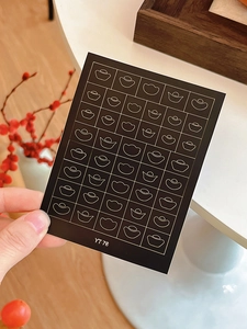 Detail view of New Year nail art stickers featuring gold sycee designs and YT76 code