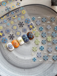 Detail of embossed bohemian nail stickers featuring vintage tile and mandala patterns
