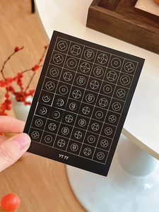 Detail of YT 77 nail art stickers with gold stars and currency symbols for manicures