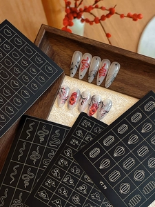 Detail of Lunar New Year nail art stickers featuring lanterns and festive motifs