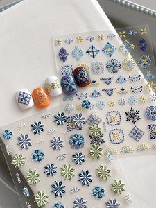 Detail of bohemian embossed nail stickers with vintage floral patterns and tile textures