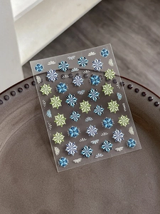 Macro detail of YT4435 embossed bohemian nail stickers with blue geometric floral patterns