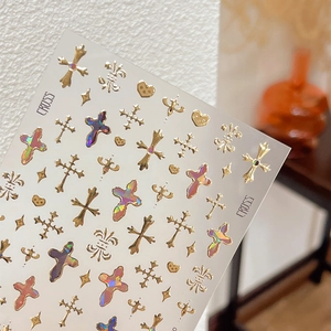 Self-adhesive gold and laser holographic nail stickers featuring heart and cross patterns