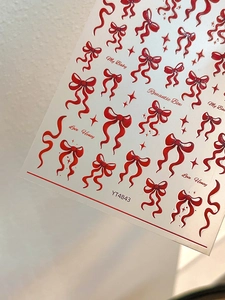 Detail of red bow and ribbon nail stickers with stars and text elements, model YT4843