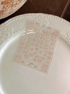 Close-up of 3D embossed nail stickers featuring bowknots and pearl chains, model YT4774