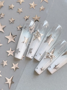 Macro detail of long coffin press-on nails with silver 3D stars and gradient finish