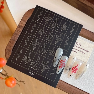 Snake nail art stickers YT74 with black and red serpent designs on a wooden tray