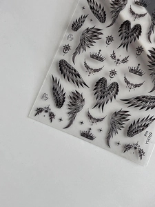 Detail of gothic wing and crown nail stickers with black and white gradient design