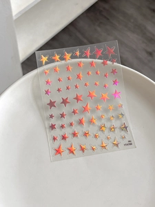 Macro detail of holographic star nail art stickers with laser colorful gradient finish
