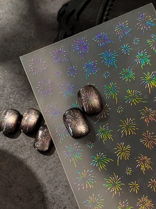 Holographic laser firework nail stickers applied on dark cat-eye polish for a luxury look