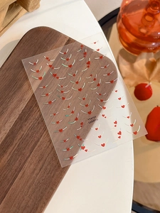 Detailed view of French heart nail stickers with silver laser finish on wood background