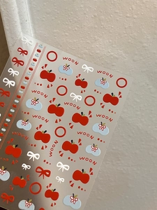 Macro detail of self-adhesive 3D embossed nail art stickers with apple and bow designs