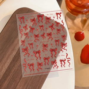 3D red bow nail art stickers with stars and ribbons on high-quality adhesive sheets