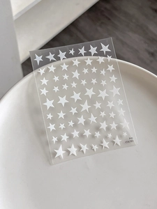 Macro shot of white pentagram nail art stickers with YT4783 model on transparent backing