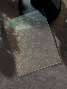 Detailed macro view of laser holographic firework nail stickers YT4474 with adhesive backing