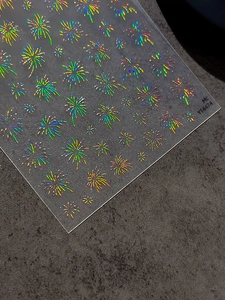 Macro detail of holographic laser firework nail stickers with adhesive backing YT4474