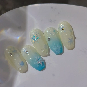 Iridescent snowflake nail stickers with rhinestones on blue gradient long coffin nails