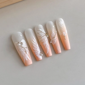 Matte gradient press-on nails with white feathers, tiny pearls, and metallic chains