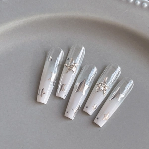 Long coffin gradient nails with sparkling silver star stickers and rhinestone accents