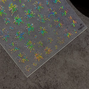 Holographic firework nail stickers with laser effect and adhesive backing on dark background