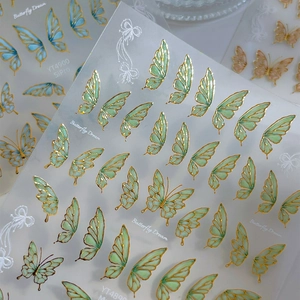Golden butterfly nail stickers with gradient translucent wings and intricate art lines