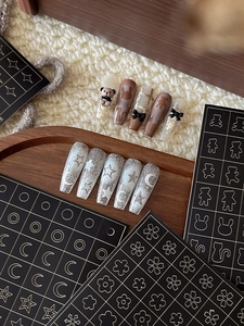 Detailed view of long trapezoid press-on nails with 3D bears and silver glitter stars